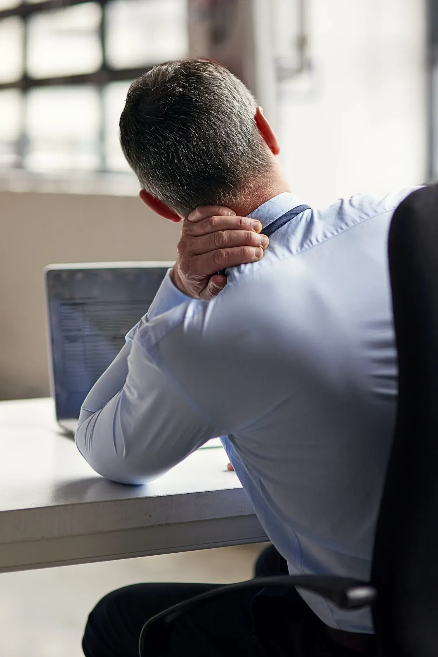 Person concerned about persistent neck discomfort at Bensa Chiropractic and Wellness Bradenton