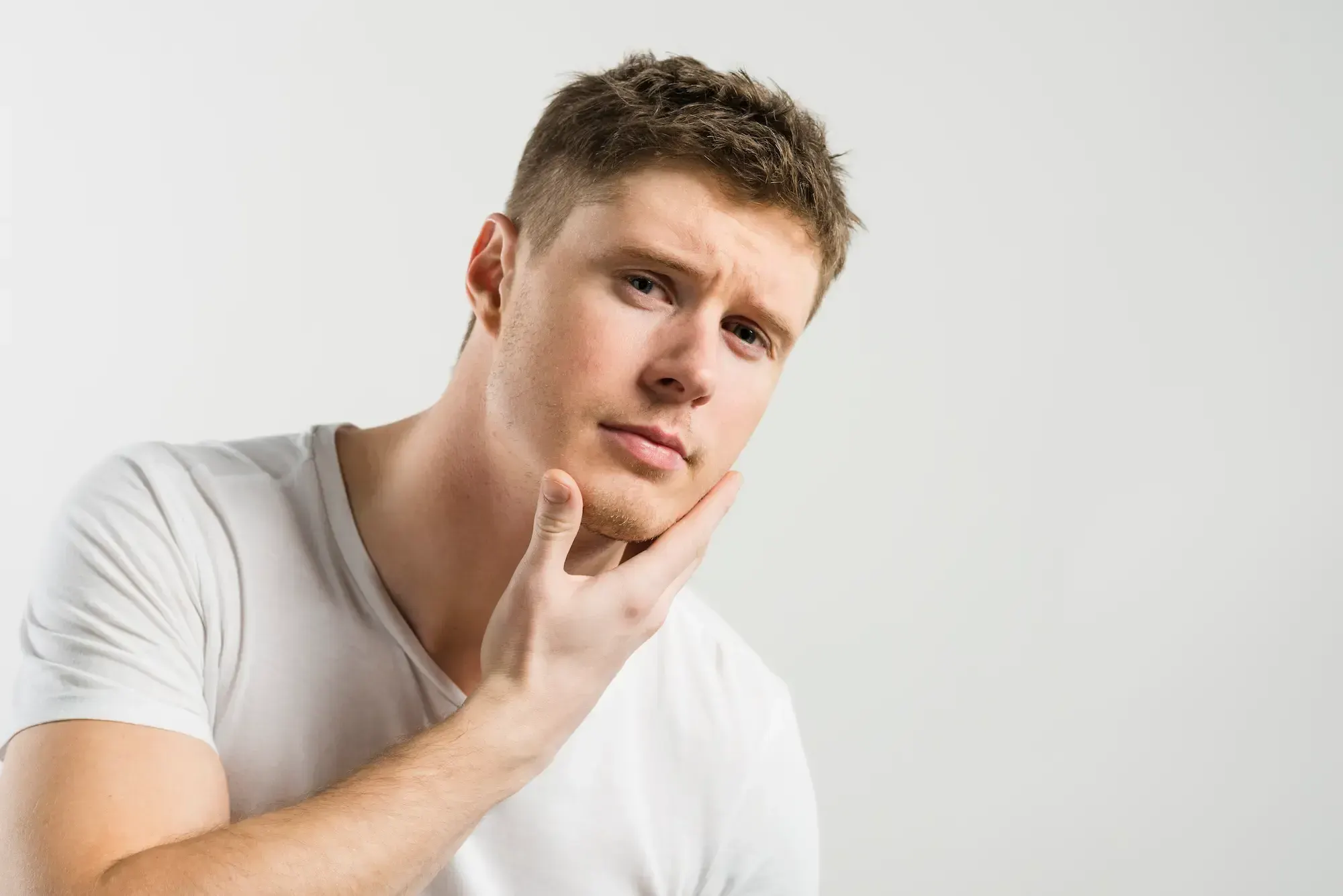 Close-up of the Emvital laser therapy applicator being used on a patient's jaw area at Bensa Chiropractic & Wellness to relieve TMJ pain and muscle tension.